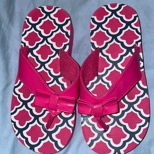 Pink patterned flip flops